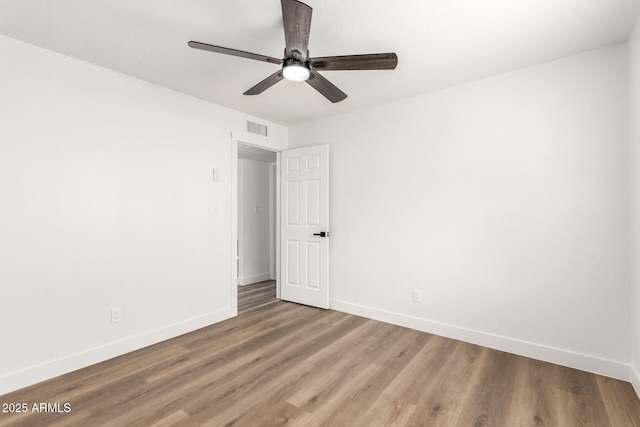 spare room with wood-type flooring and ceiling fan