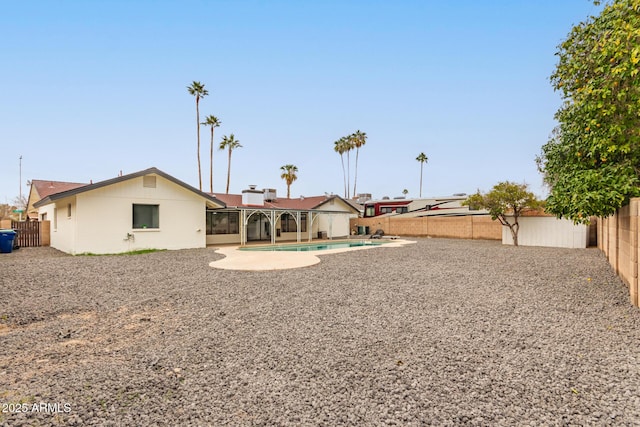 exterior space with a fenced in pool and a patio area