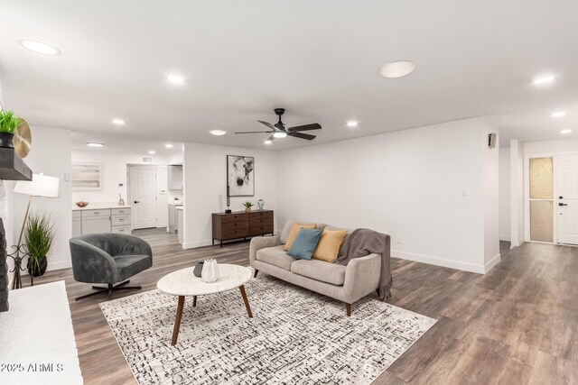 living room featuring ceiling fan and hardwood / wood-style flooring