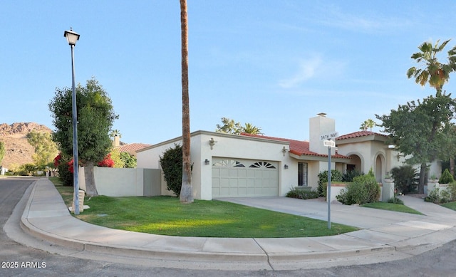 3417 E Mission Ln E, Phoenix, AZ 85028 - view of front of house with a tiled roof, an attached garage, stucco siding, concrete driveway, and a chimney
