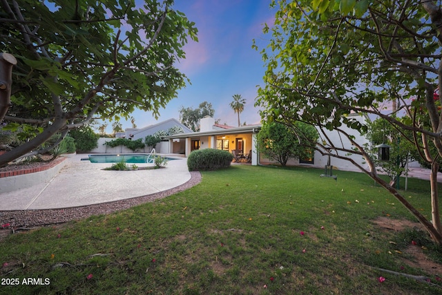 3417 E Mission Ln E, Phoenix, AZ 85028 - back of property at dusk featuring an outdoor pool, a patio area, and a chimney
