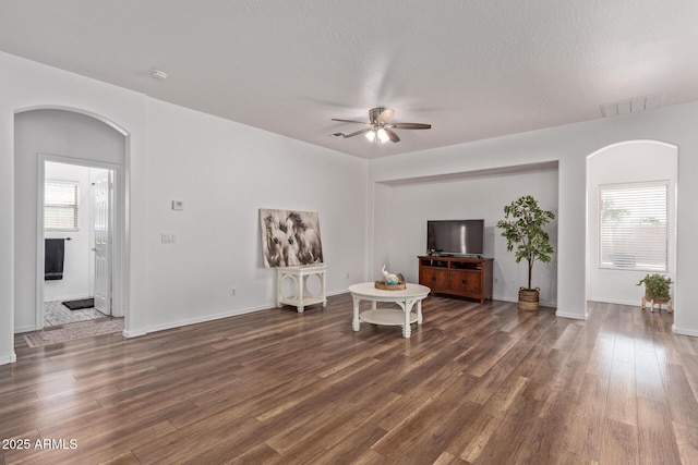 15246 N 138th Ln, Surprise, AZ 85379 - living area with arched walkways, wood finished floors, visible vents, and ceiling fan