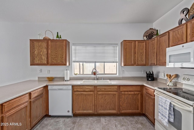 15246 N 138th Ln, Surprise, AZ 85379 - kitchen featuring light countertops, white appliances, a sink, and brown cabinets