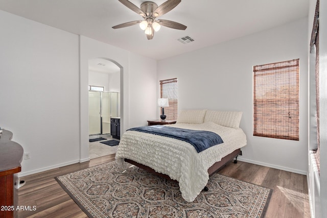 15246 N 138th Ln, Surprise, AZ 85379 - bedroom featuring baseboards, wood finished floors, visible vents, and arched walkways