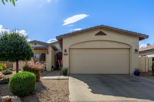 15246 N 138th Ln, Surprise, AZ 85379 - mediterranean / spanish-style home featuring an attached garage, a tiled roof, stucco siding, and driveway