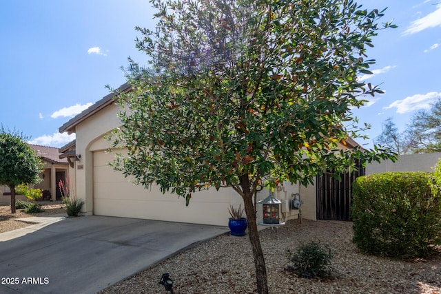 15246 N 138th Ln, Surprise, AZ 85379 - view of front of property featuring a garage, a tile roof, driveway, and stucco siding