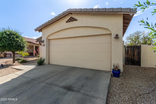 15246 N 138th Ln, Surprise, AZ 85379 - view of front of property with concrete driveway, an attached garage, a gate, and stucco siding