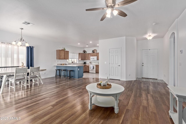15246 N 138th Ln, Surprise, AZ 85379 - living area with recessed lighting, dark wood-style flooring, visible vents, and ceiling fan with notable chandelier