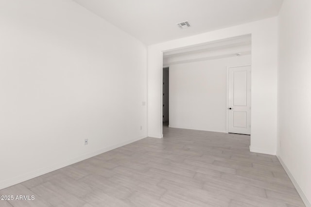 spare room featuring visible vents and light wood-style floors