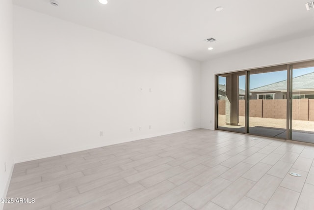 unfurnished room featuring baseboards, visible vents, and recessed lighting