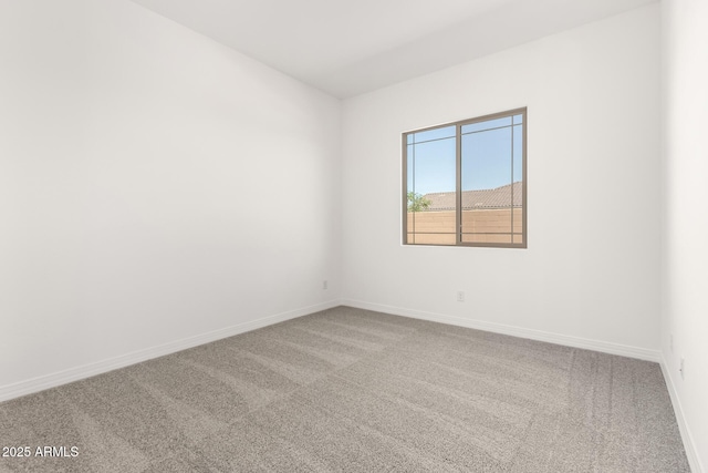 unfurnished room featuring baseboards and carpet floors