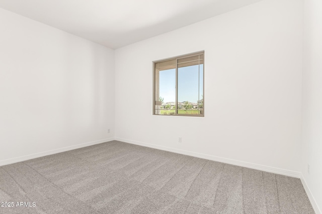 unfurnished room featuring carpet flooring and baseboards