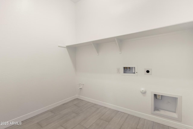 washroom with washer hookup, light wood-style flooring, gas dryer hookup, baseboards, and laundry area