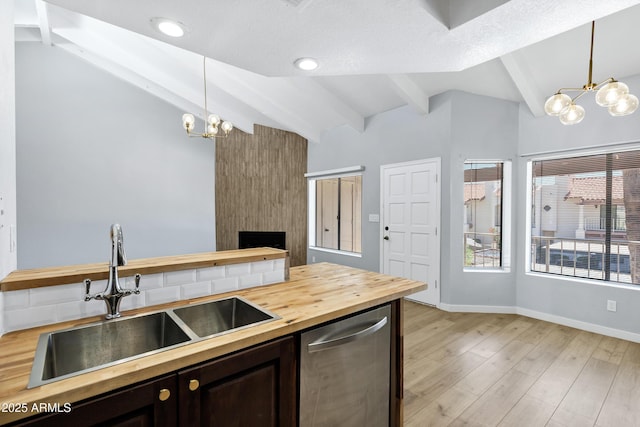 1017 E Maryland Ave Unit 236, Phoenix, AZ 85014 - kitchen featuring a sink, lofted ceiling with beams, a notable chandelier, stainless steel dishwasher, and butcher block counters