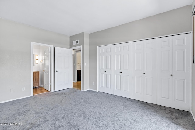 1017 E Maryland Ave Unit 236, Phoenix, AZ 85014 - unfurnished bedroom with a closet, baseboards, carpet flooring, ensuite bath, and visible vents