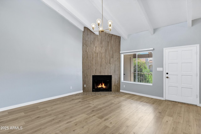 1017 E Maryland Ave Unit 236, Phoenix, AZ 85014 - unfurnished living room with a fireplace, beamed ceiling, high vaulted ceiling, and a notable chandelier