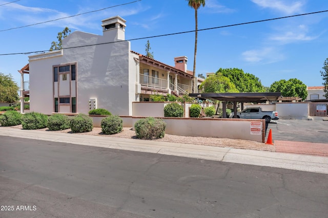 1017 E Maryland Ave Unit 236, Phoenix, AZ 85014 - exterior space featuring a chimney and stucco siding