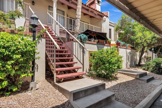 1017 E Maryland Ave Unit 236, Phoenix, AZ 85014 - exterior space featuring stucco siding, a tile roof, and a chimney