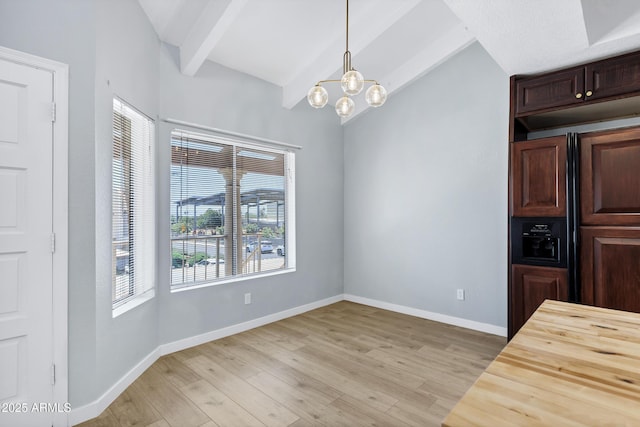1017 E Maryland Ave Unit 236, Phoenix, AZ 85014 - unfurnished dining area with light wood finished floors, a chandelier, baseboards, and vaulted ceiling with beams