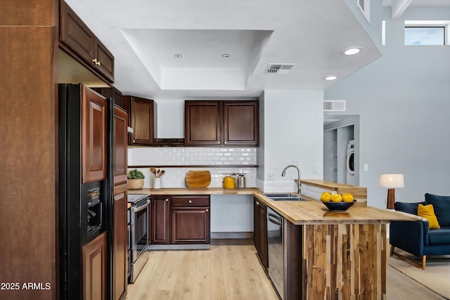 1017 E Maryland Ave Unit 236, Phoenix, AZ 85014 - kitchen with wooden counters, visible vents, a sink, a peninsula, and appliances with stainless steel finishes