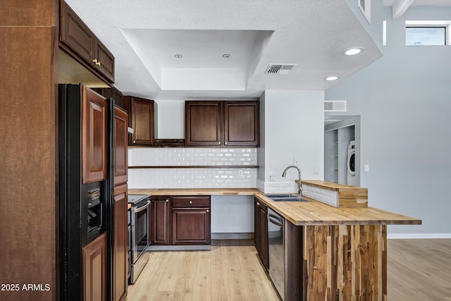 1017 E Maryland Ave Unit 236, Phoenix, AZ 85014 - kitchen with a sink, a peninsula, visible vents, wooden counters, and appliances with stainless steel finishes