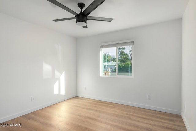 spare room with light wood-type flooring and ceiling fan