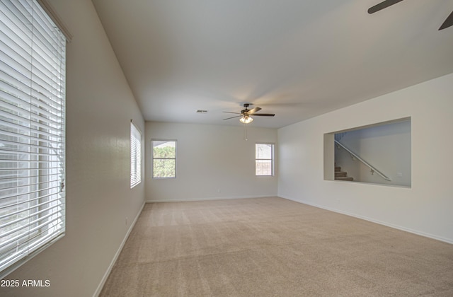 6192 S Claiborne Ave, Gilbert, AZ 85298 - empty room with baseboards, visible vents, light colored carpet, and a ceiling fan