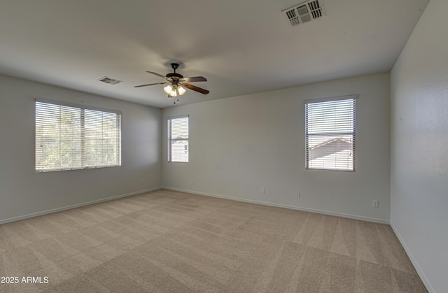 6192 S Claiborne Ave, Gilbert, AZ 85298 - empty room featuring visible vents, light colored carpet, baseboards, and ceiling fan