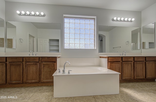 6192 S Claiborne Ave, Gilbert, AZ 85298 - bathroom featuring tile patterned floors, a garden tub, and two vanities