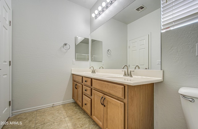 6192 S Claiborne Ave, Gilbert, AZ 85298 - full bath with visible vents, baseboards, a sink, toilet, and double vanity