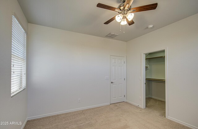 6192 S Claiborne Ave, Gilbert, AZ 85298 - unfurnished bedroom with a spacious closet, visible vents, baseboards, and light colored carpet
