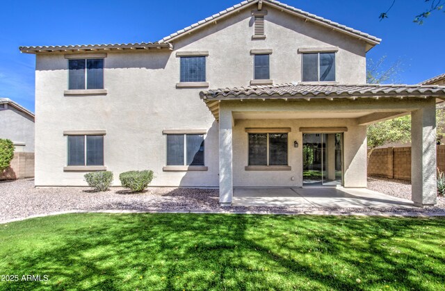 6192 S Claiborne Ave, Gilbert, AZ 85298 - back of house featuring a patio, stucco siding, a tile roof, a yard, and fence