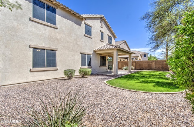 6192 S Claiborne Ave, Gilbert, AZ 85298 - rear view of house featuring a patio, stucco siding, fence, and a tile roof