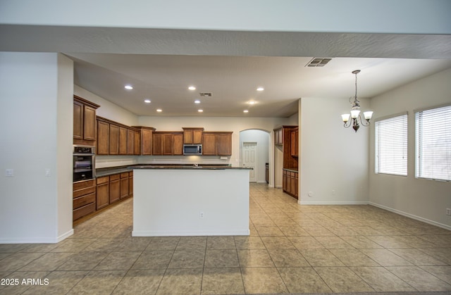 6192 S Claiborne Ave, Gilbert, AZ 85298 - kitchen featuring arched walkways, recessed lighting, appliances with stainless steel finishes, dark countertops, and a notable chandelier