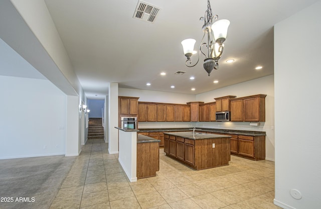 6192 S Claiborne Ave, Gilbert, AZ 85298 - kitchen featuring visible vents, a kitchen island with sink, brown cabinetry, recessed lighting, and stainless steel appliances