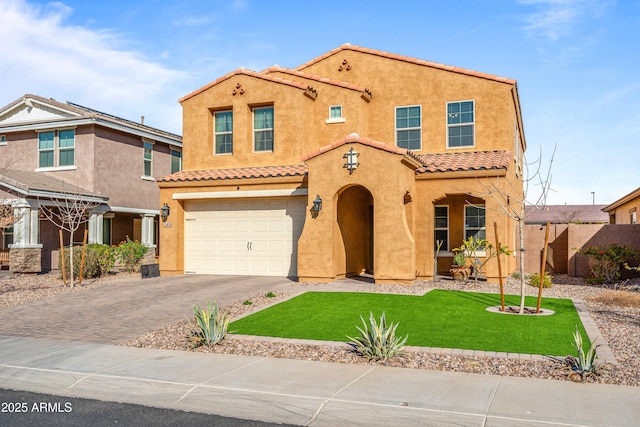 mediterranean / spanish-style house featuring a garage and a front yard