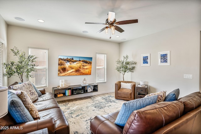 living room with hardwood / wood-style flooring, ceiling fan, and plenty of natural light