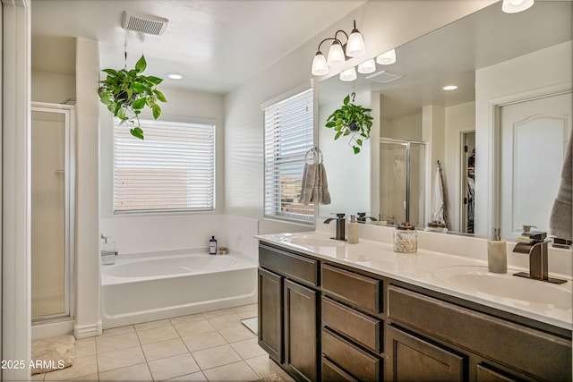 bathroom with tile patterned flooring, vanity, and separate shower and tub