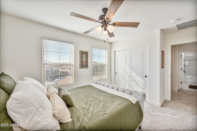 carpeted bedroom with ceiling fan and a closet