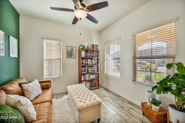 living area featuring ceiling fan and light hardwood / wood-style floors