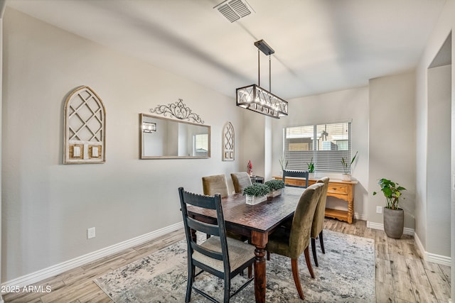 dining space with light hardwood / wood-style flooring