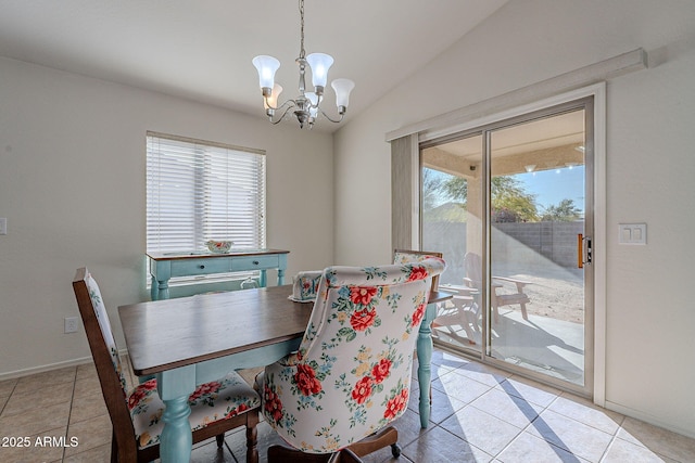 dining area featuring vaulted ceiling, light tile patterned floors, and a chandelier