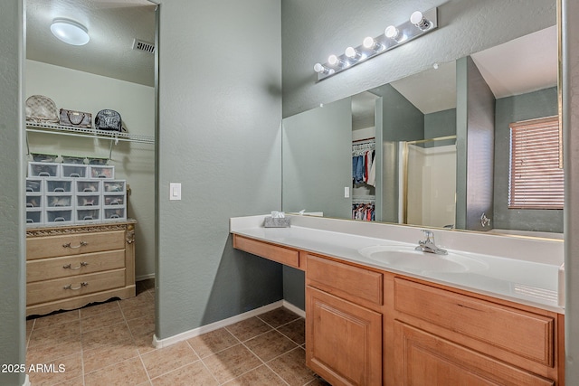 bathroom with walk in shower and vanity