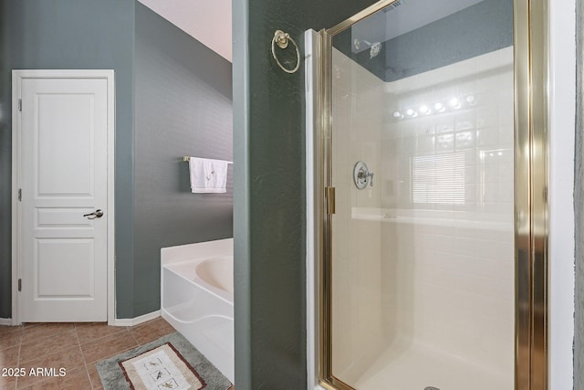 bathroom featuring tile patterned flooring and separate shower and tub