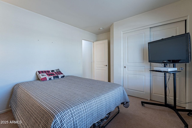 bedroom featuring carpet and a closet