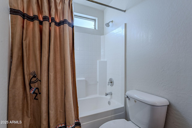 bathroom featuring shower / tub combo and toilet