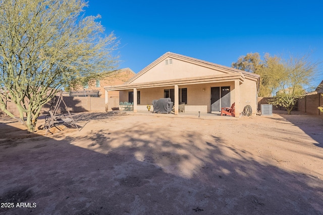 rear view of property featuring a patio and central AC