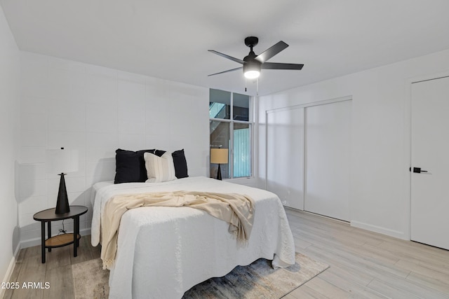 bedroom with ceiling fan and light hardwood / wood-style flooring