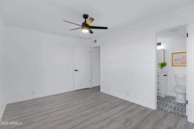 unfurnished bedroom with ceiling fan, ensuite bathroom, and light hardwood / wood-style floors