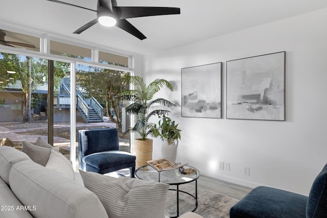 living room with ceiling fan and light hardwood / wood-style flooring